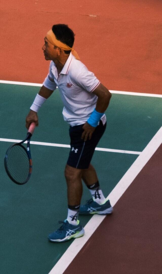 A tennis player waiting to receive serve